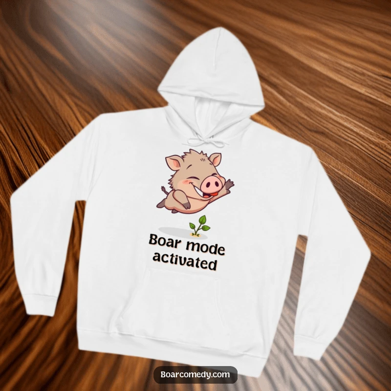 Funny hoodie showcasing a cheerful boar character leaping bravely over a tiny green sprout with a wide, determined smile.