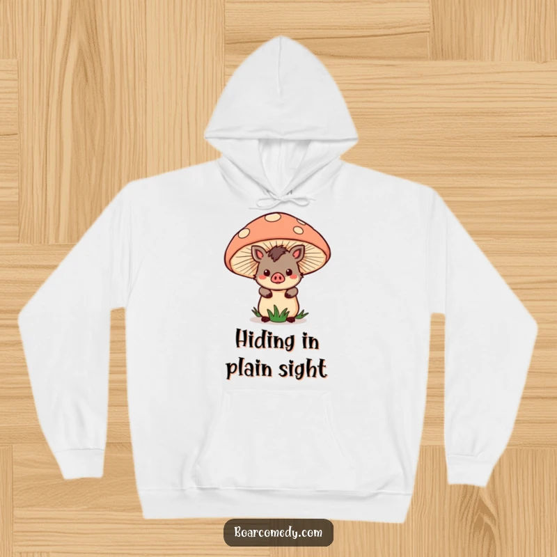 Funny Hoodie: Kawaii boar character hiding behind a giant mushroom, offering warmth and a touch of magical cuteness.